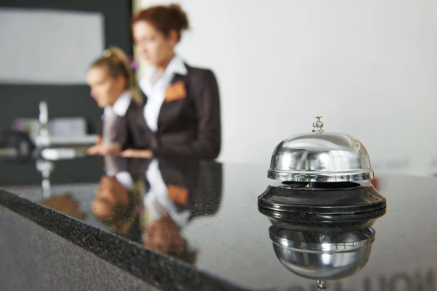 Hospitality Services - Professional concierge desk with service bell